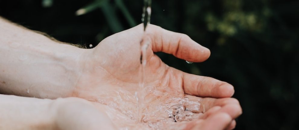 water drop on persons hand